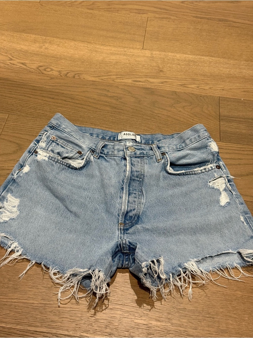 Agolde Washed Light Blue Distressed Denim Cutoff Shorts. Dee